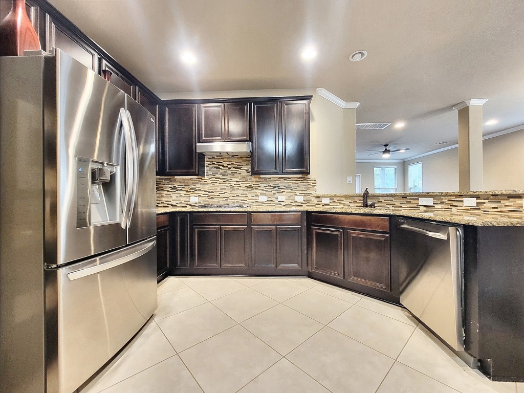 7508 Colina Vista Loop, Unit B Austin, TX 78750 - Photo 8 of 40 a kitchen with stainless steel appliances granite countertop a refrigerator a sink and a stove
