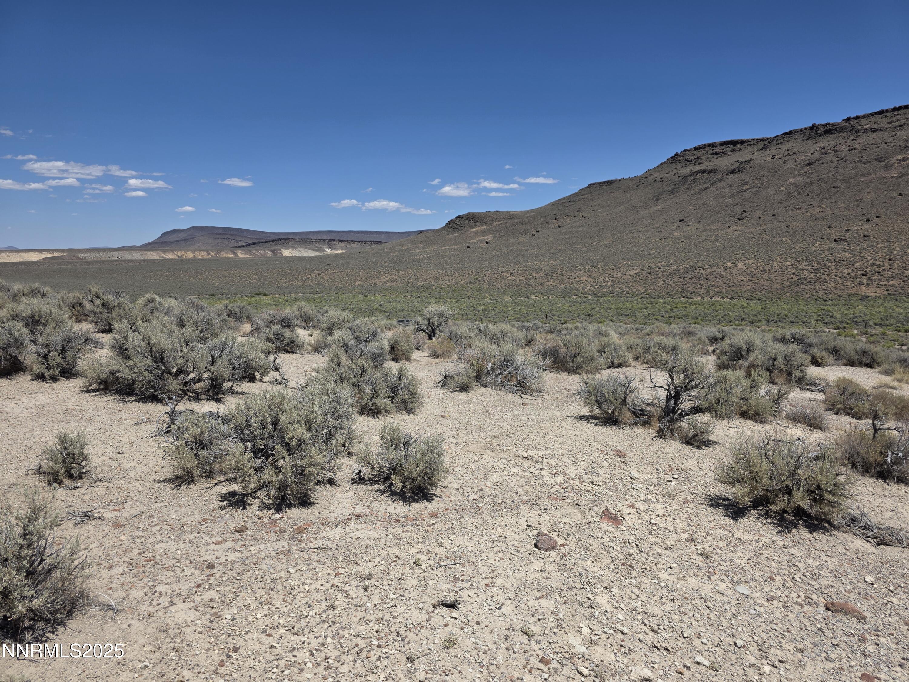 3301 High Rock Road, Unit US HIGHWAY 34 NORTH OUT OF GERLACH TO HIGH ROCK RD Reno, NV 89510 - Photo 22 of 47 a view of a dry yard with mountains in the background