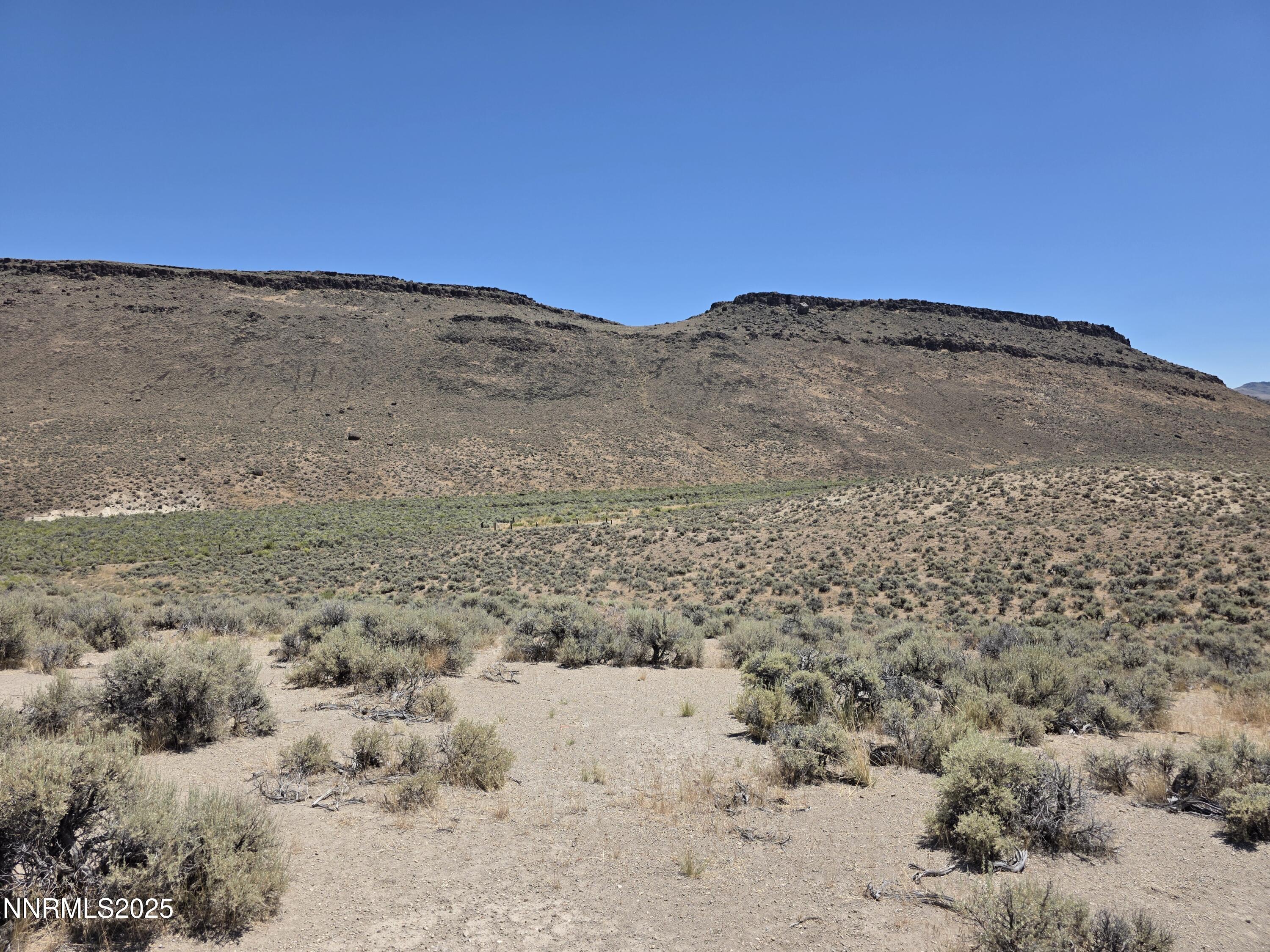 3301 High Rock Road, Unit US HIGHWAY 34 NORTH OUT OF GERLACH TO HIGH ROCK RD Reno, NV 89510 - Photo 33 of 47 a view of a dry field with mountains in the background