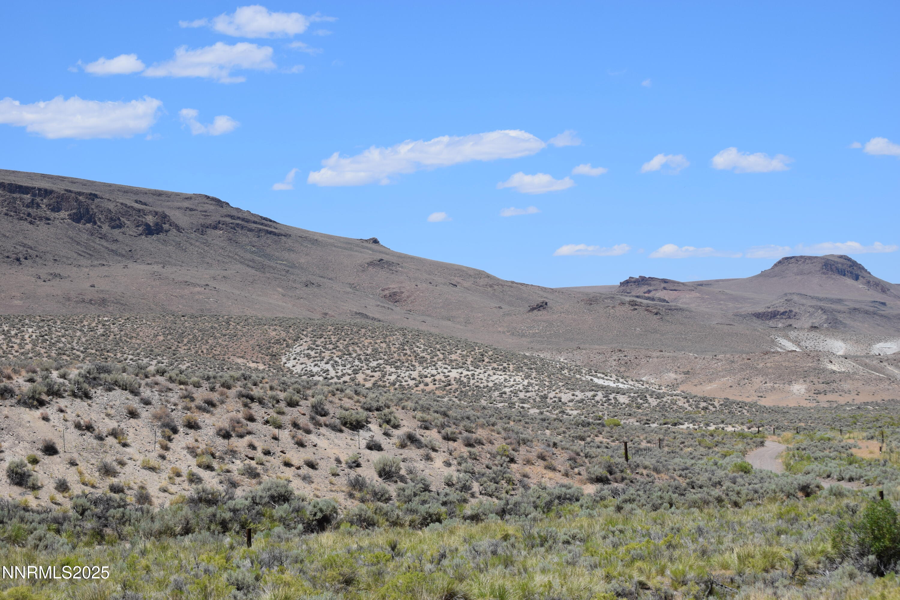 3301 High Rock Road, Unit US HIGHWAY 34 NORTH OUT OF GERLACH TO HIGH ROCK RD Reno, NV 89510 - Photo 43 of 47 a view of a dry yard with mountains in the background
