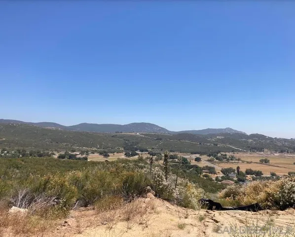 a view of a town with mountains in the background