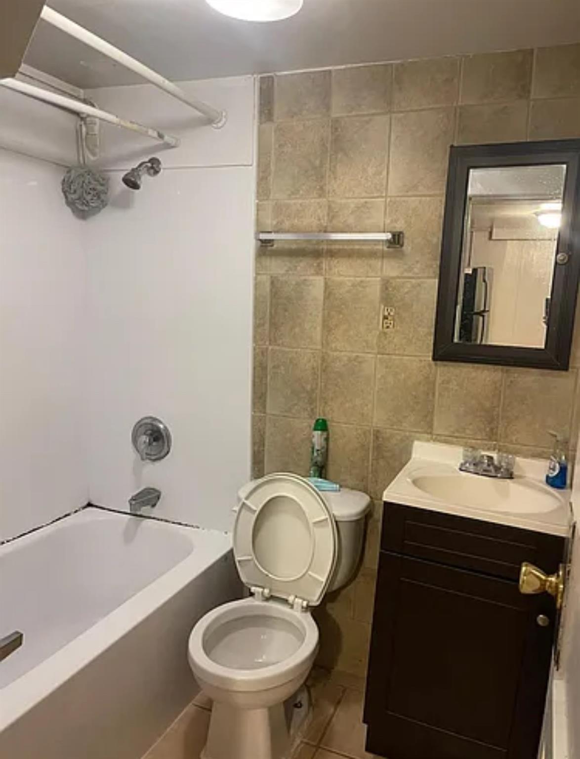 2564 Paulding Avenue Bronx, NY 10469 - Photo 11 of 14 Full bath featuring vanity, tile walls, tile patterned flooring, and shower / bath combination