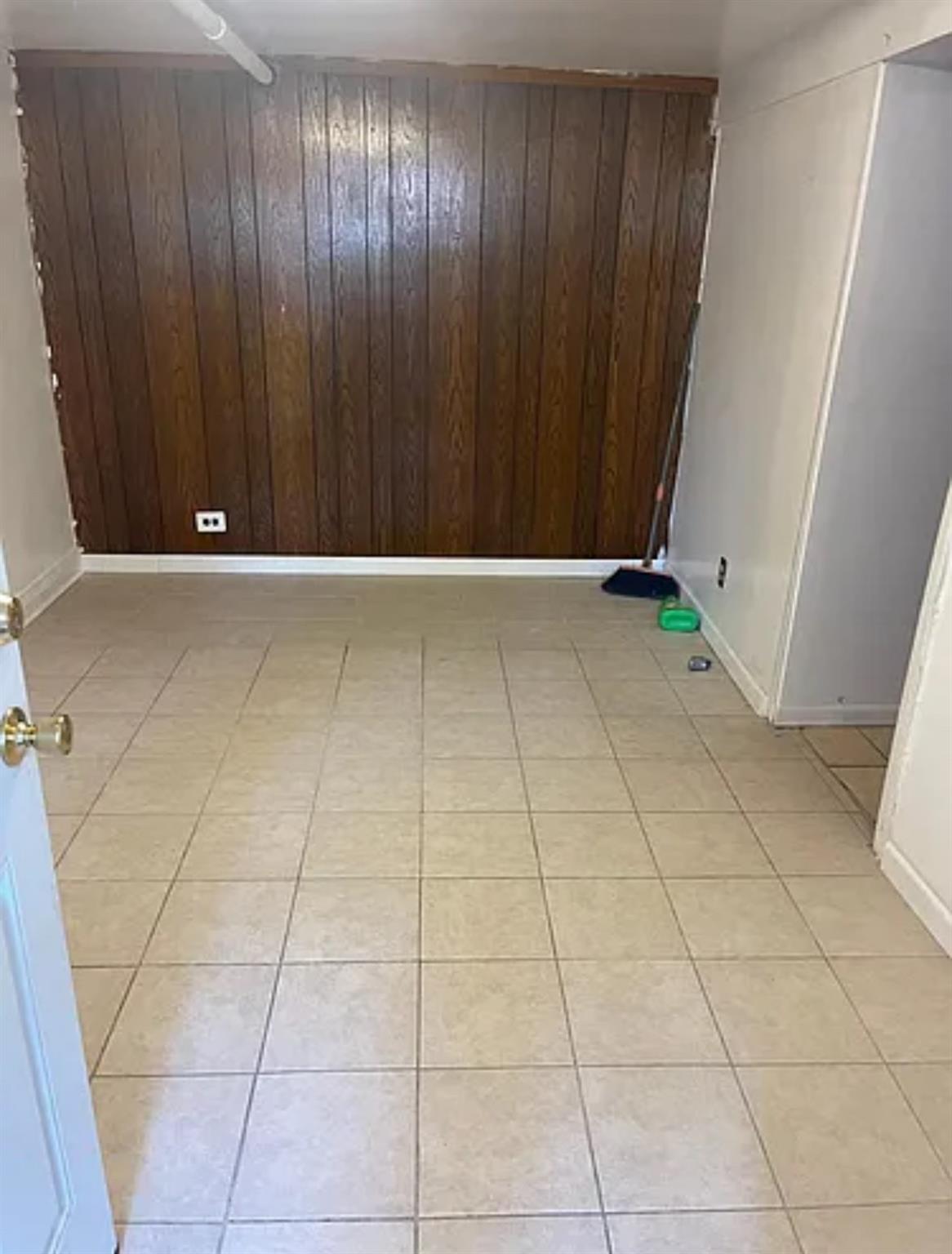 2564 Paulding Avenue Bronx, NY 10469 - Photo 13 of 14 Unfurnished room with wooden walls and light tile patterned floors