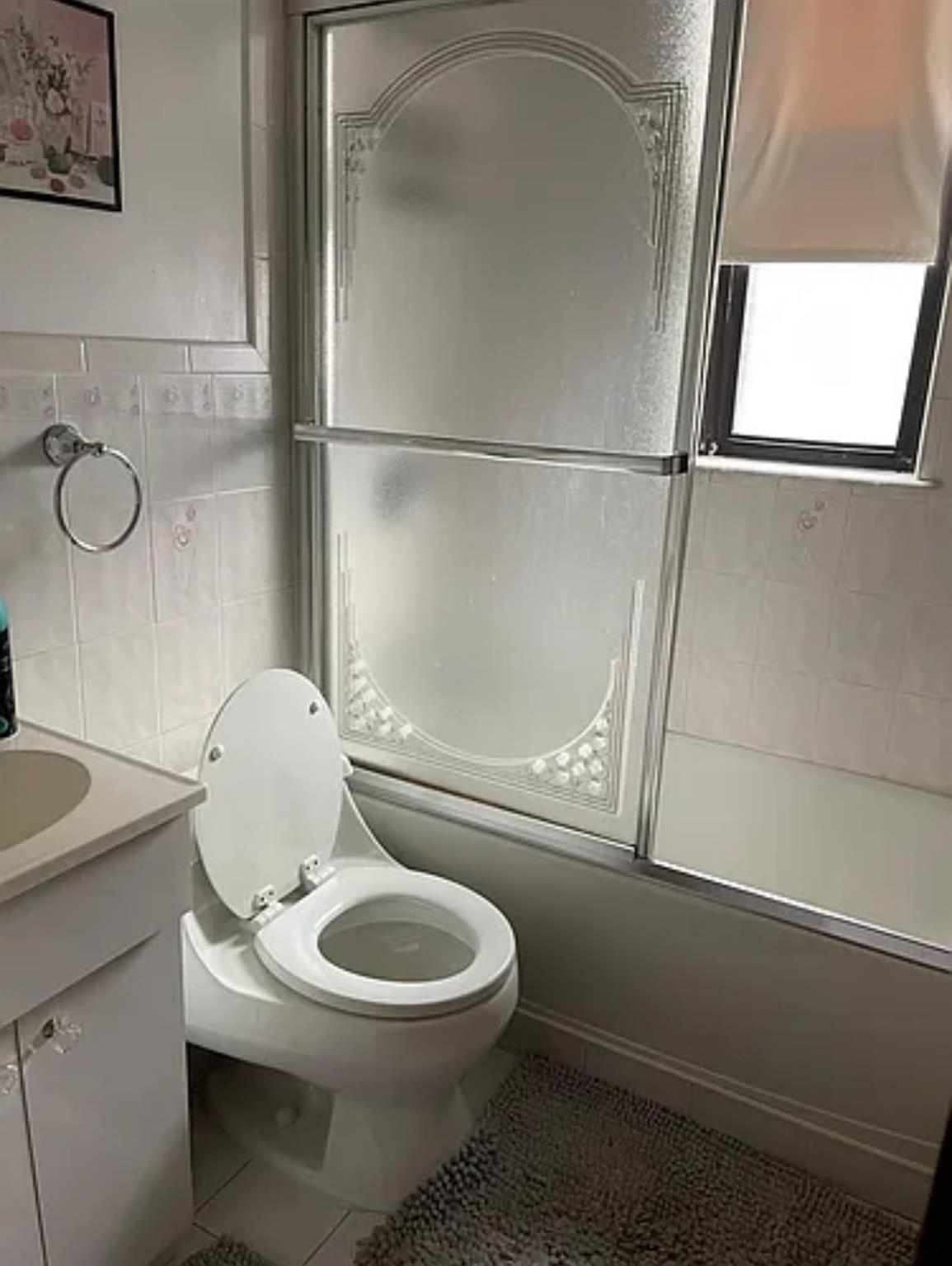 2564 Paulding Avenue Bronx, NY 10469 - Photo 9 of 14 Bathroom with tile walls, tile patterned flooring, combined bath / shower with glass door, and vanity