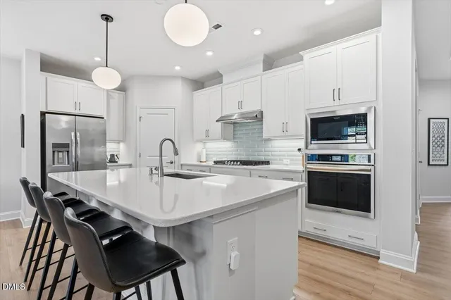 a spacious bathroom with double sink and a mirror