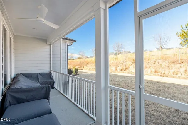 a hallway with wooden floor and paintings on the wall
