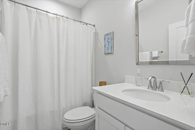 a view of a dining room with furniture a chandelier and wooden floor