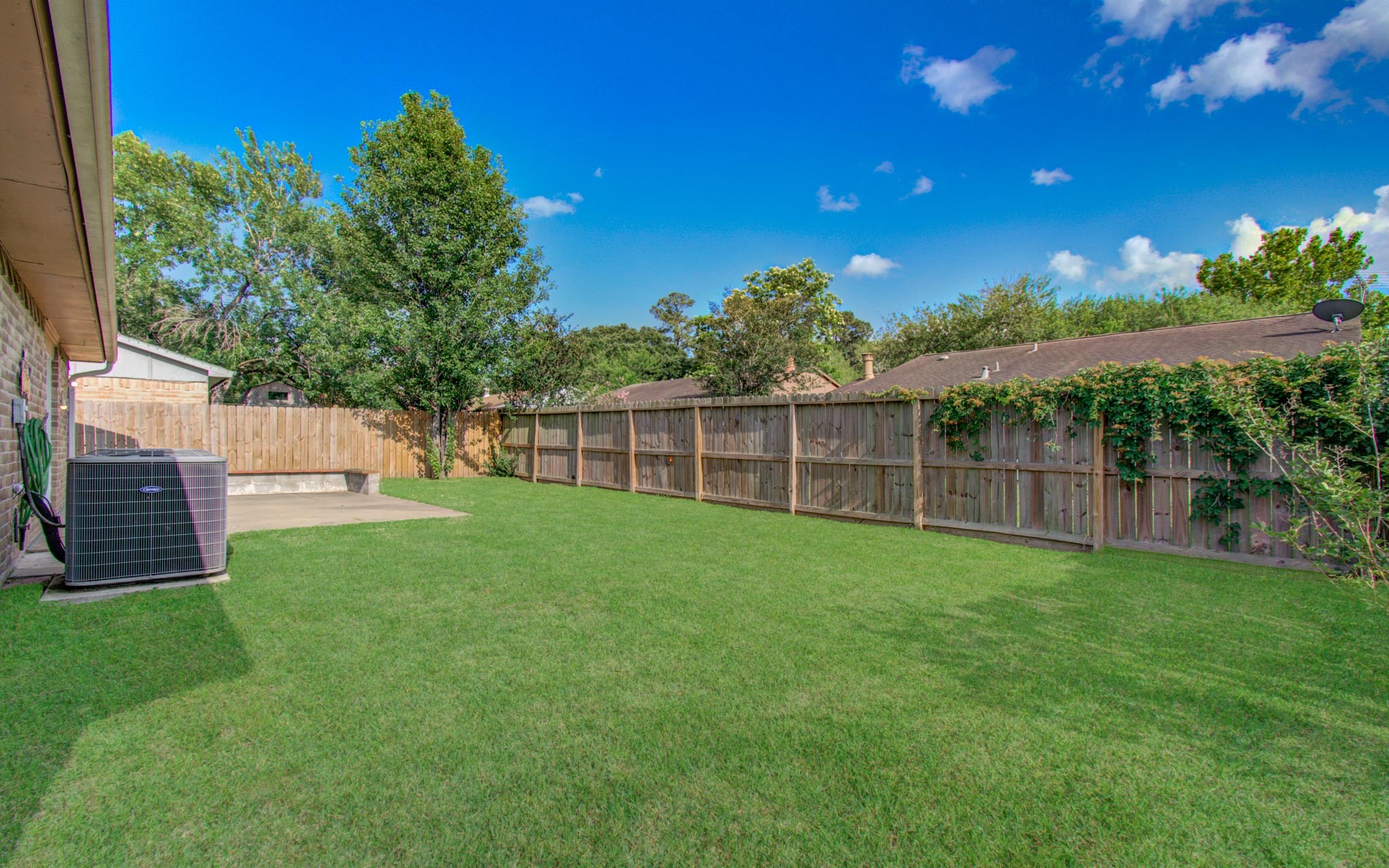 5706 Spring Grove Lane Spring, TX 77373 - Photo 12 of 12 a view of a backyard with a garden and deck
