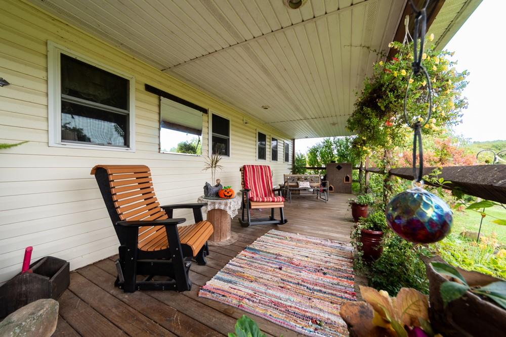 11 Fairgrounds Road Stoneboro, PA 16153 - Photo 32 of 37 a patio with table and chairs potted plants and large tree