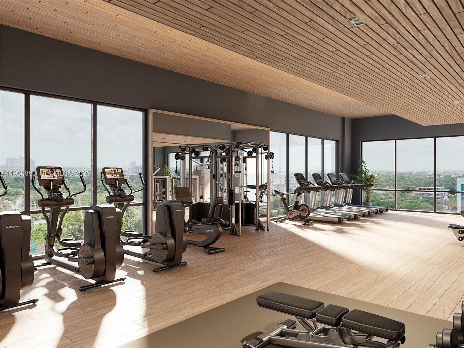1741 Southwest 2nd Avenue, Unit 427 Miami, FL 33129 - Photo 8 of 13 a room with gym equipment and large windows