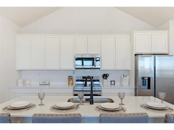 a kitchen with a refrigerator and cabinets