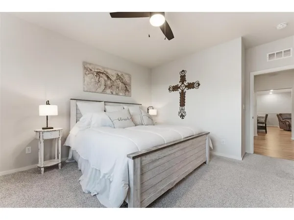 a spacious bedroom with a bed and a view of bathroom