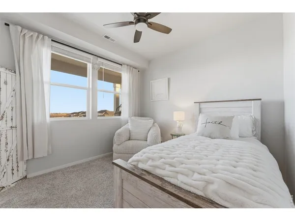 a bedroom with a large bed and a window