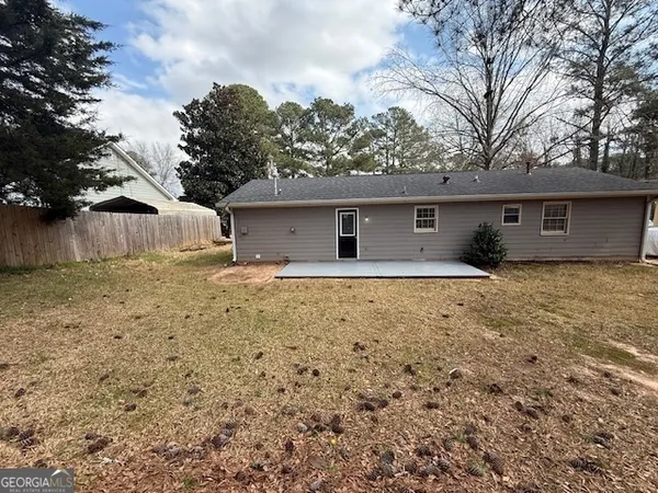 a house with trees in the background
