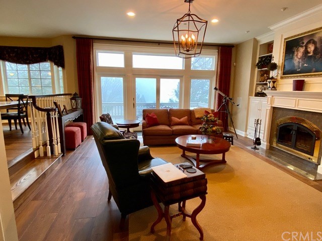 1010 Black Oaks Drive Lake Arrowhead, CA 92352 - Photo 27 of 52 a living room with furniture a chandelier and a fireplace
