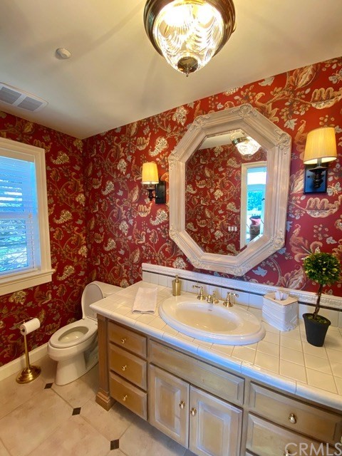 1010 Black Oaks Drive Lake Arrowhead, CA 92352 - Photo 29 of 52 a bathroom with a sink mirror vanity and toilet