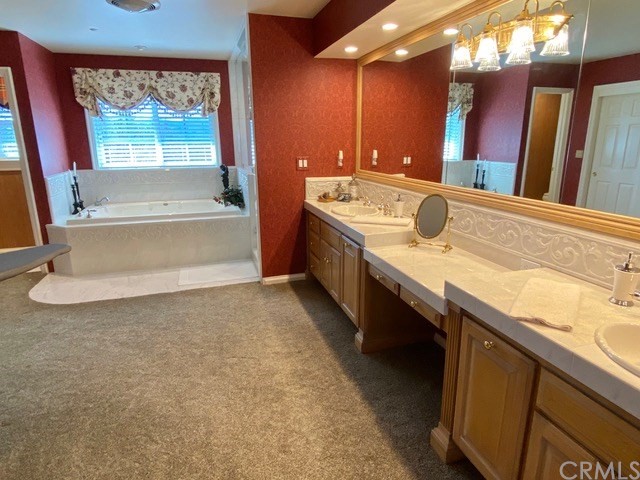 1010 Black Oaks Drive Lake Arrowhead, CA 92352 - Photo 32 of 52 a bathroom with a granite countertop sink and a large mirror