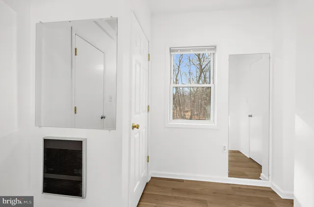 a view of an entryway with wooden floor