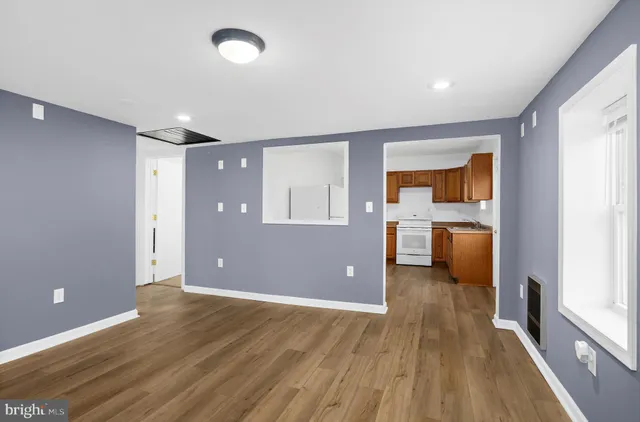 a view of a room with wooden floor and a bathroom