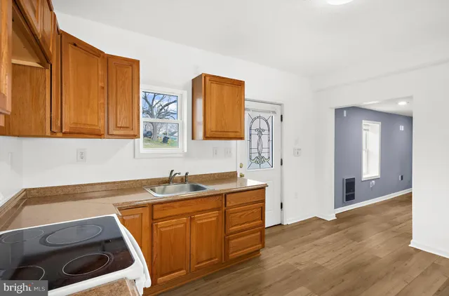 a kitchen with a sink and a stove top oven