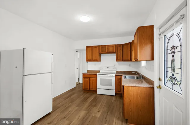 a kitchen with stainless steel appliances a stove a refrigerator and cabinets