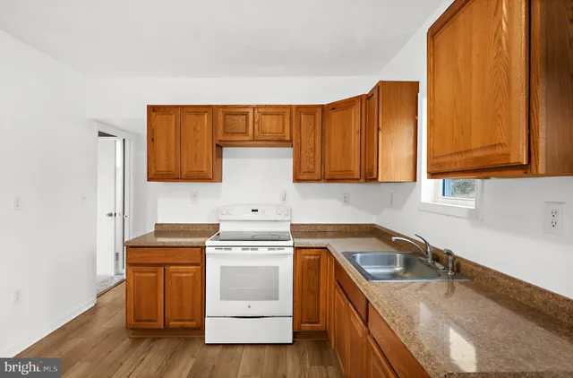a kitchen with a sink stove and cabinets