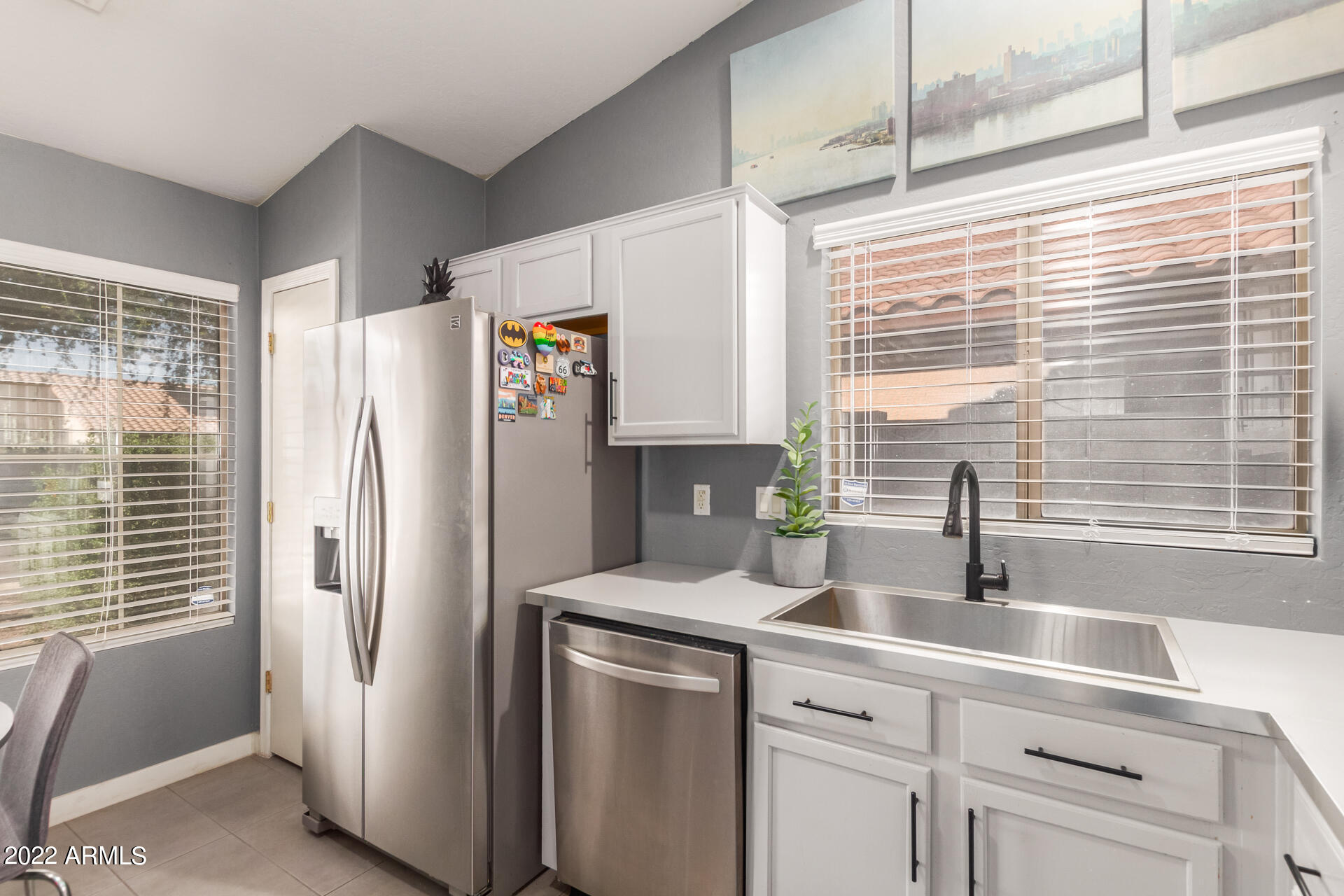 5515 South 15th Way Phoenix, AZ 85040 - Photo 14 of 28 a kitchen with refrigerator a sink and cabinets