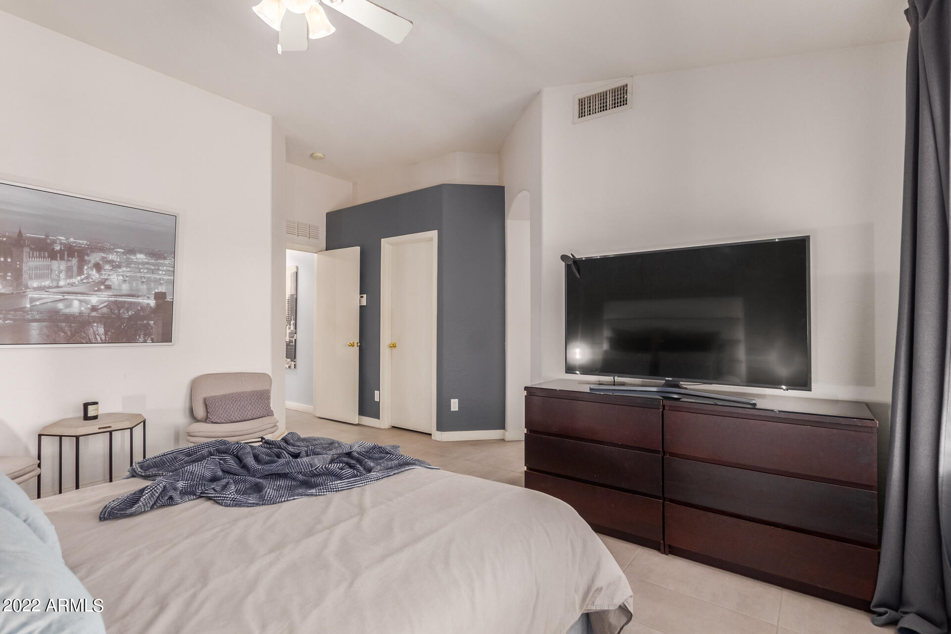 5515 South 15th Way Phoenix, AZ 85040 - Photo 19 of 28 a bedroom with a bed and a flat screen tv