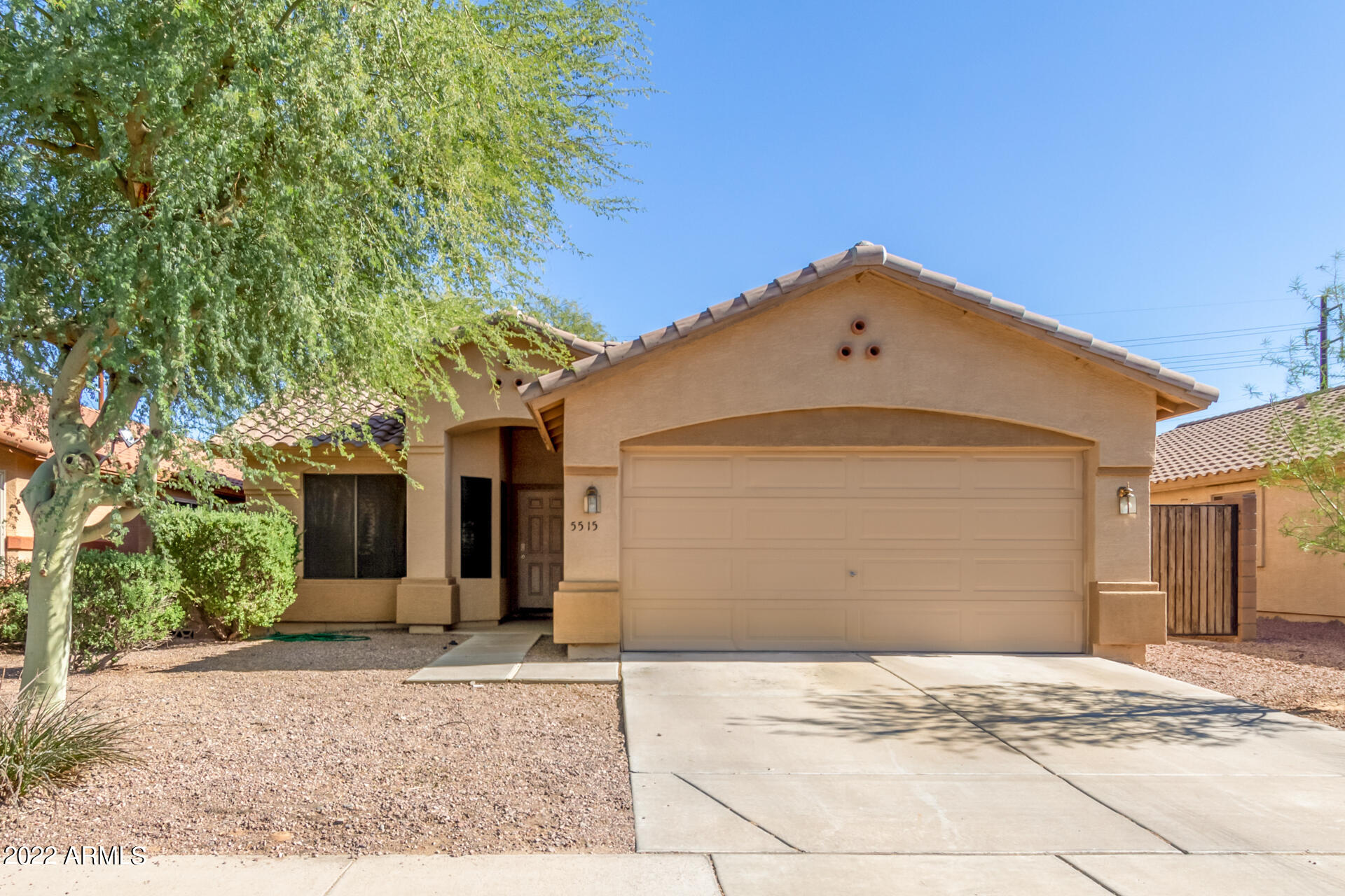 5515 South 15th Way Phoenix, AZ 85040 - Photo 2 of 28 a front view of a house with a yard and garage