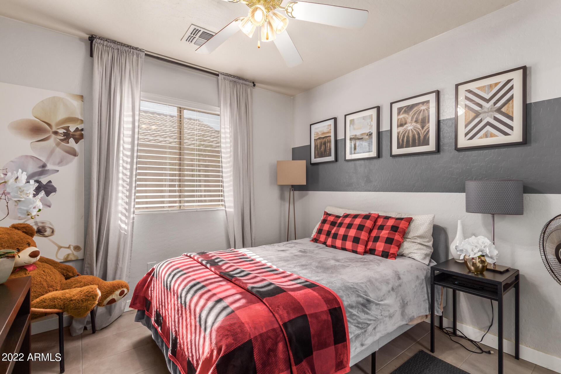 5515 South 15th Way Phoenix, AZ 85040 - Photo 21 of 28 a bedroom with a bed and a chandelier