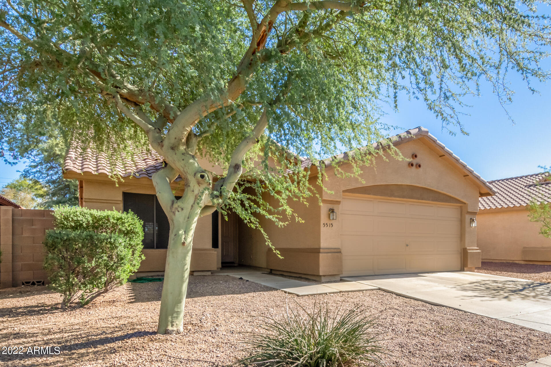 5515 South 15th Way Phoenix, AZ 85040 - Photo 4 of 28 a front view of a house with a yard and garage