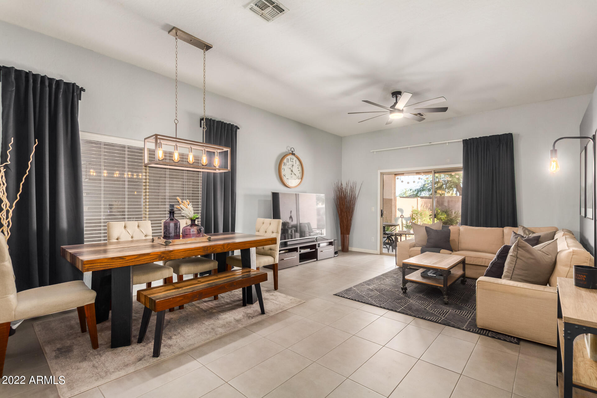 5515 South 15th Way Phoenix, AZ 85040 - Photo 7 of 28 a living room with furniture a table and a chandelier