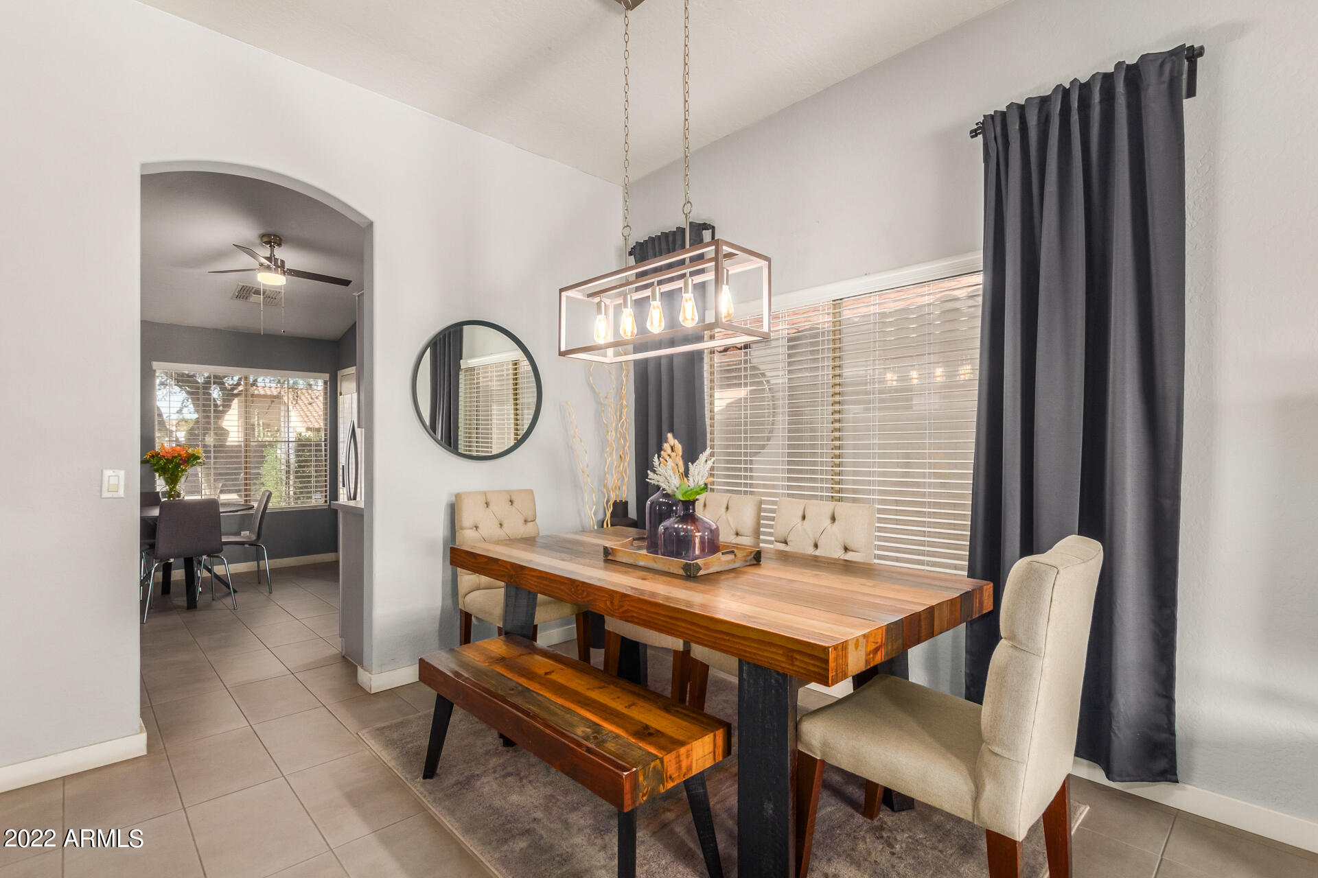 5515 South 15th Way Phoenix, AZ 85040 - Photo 8 of 28 a dining room with furniture a chandelier and a rug