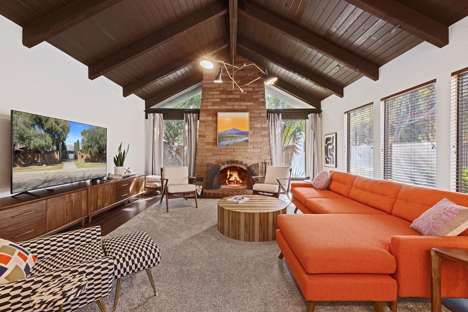 591 East Tuolumne Road Turlock, CA 95382 - Photo 1 of 1 a living room with furniture a flat screen tv and a fireplace