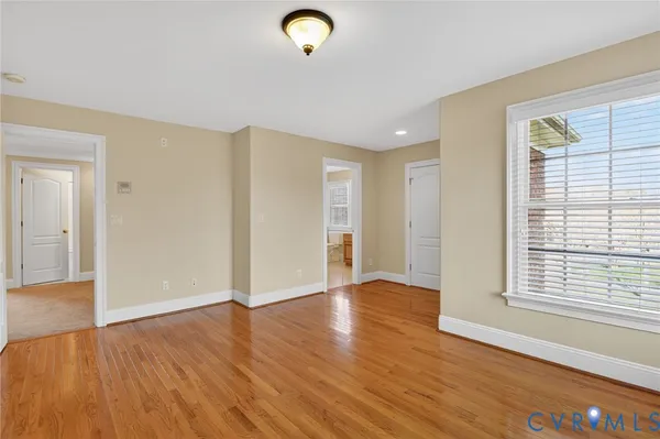 a view of an empty room with a ceiling fan