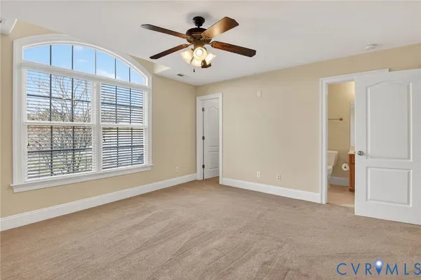an empty room with windows and chandelier