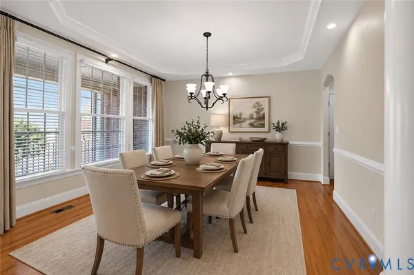a spacious bedroom with a bed and a chandelier