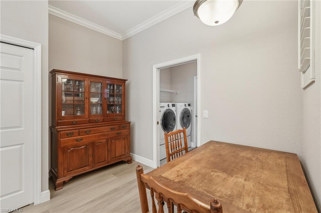 3653 Periwinkle Way Naples, FL 34114 - Photo 16 of 49 Laundry room with ornamental molding, light wood finished floors, and separate washer and dryer
