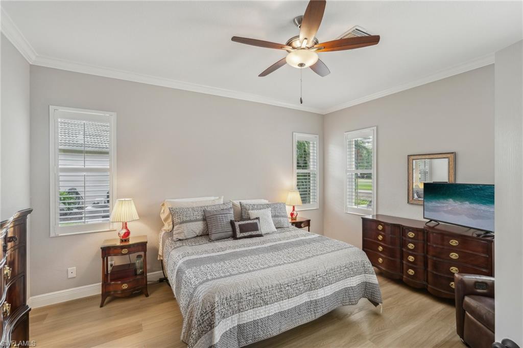 3653 Periwinkle Way Naples, FL 34114 - Photo 17 of 49 Bedroom featuring light wood finished floors, ornamental molding, and a ceiling fan