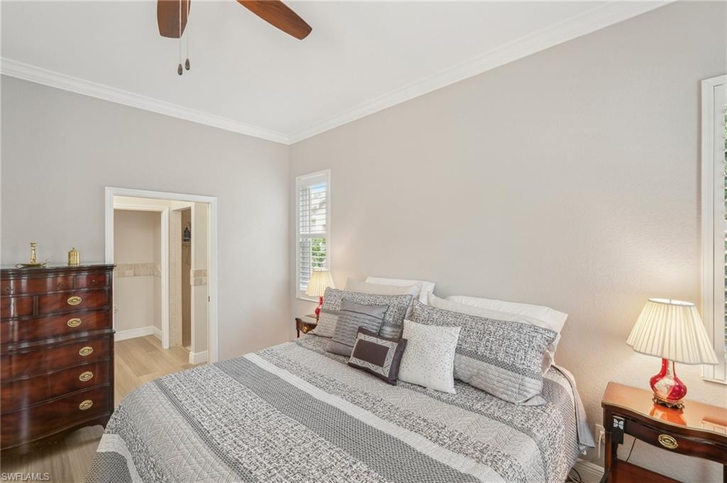 3653 Periwinkle Way Naples, FL 34114 - Photo 18 of 49 Bedroom with crown molding, wood finished floors, and a ceiling fan