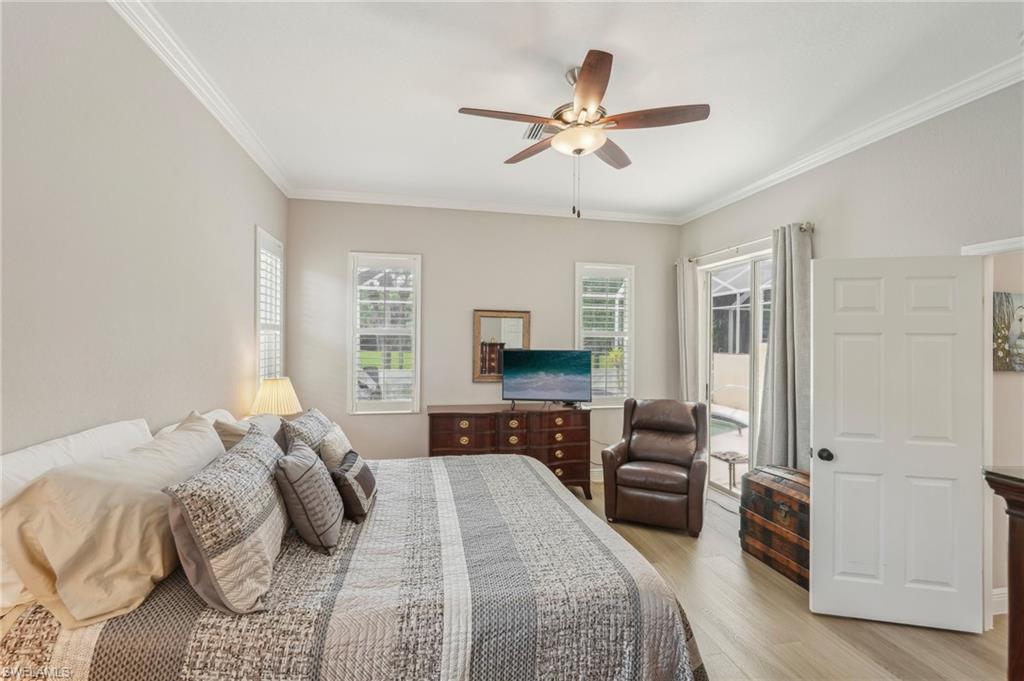 3653 Periwinkle Way Naples, FL 34114 - Photo 19 of 49 Bedroom featuring ornamental molding, light wood-type flooring, a ceiling fan, and access to outside