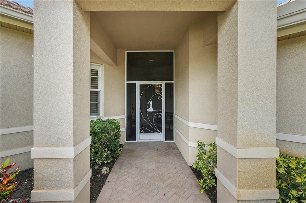 3653 Periwinkle Way Naples, FL 34114 - Photo 2 of 49 Property entrance with stucco siding