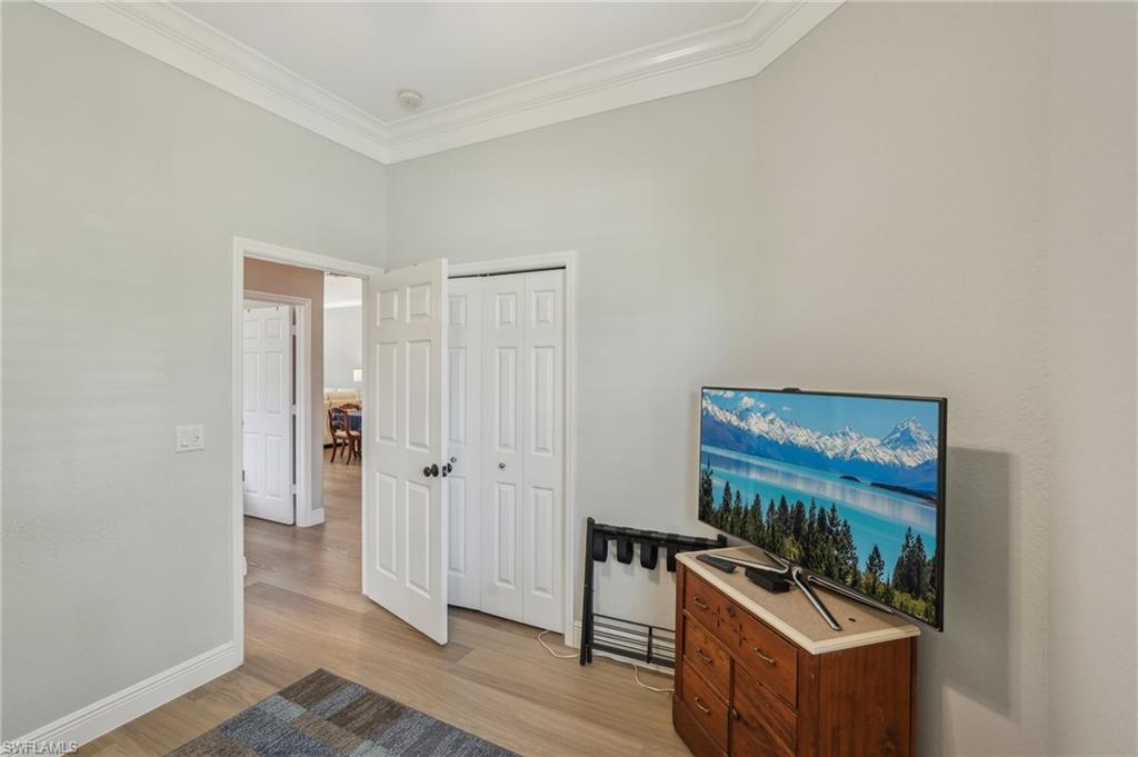 3653 Periwinkle Way Naples, FL 34114 - Photo 28 of 49 Living area with light wood-style flooring and ornamental molding