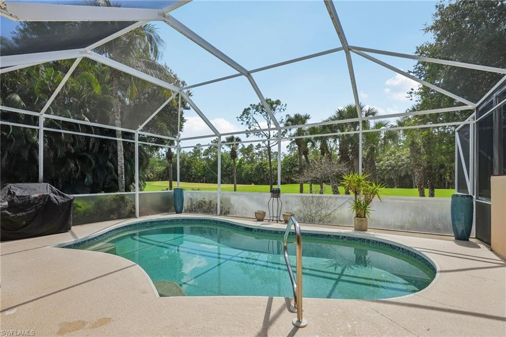 3653 Periwinkle Way Naples, FL 34114 - Photo 31 of 49 Swimming pool with a sunroom, a grill, glass enclosure, and a patio