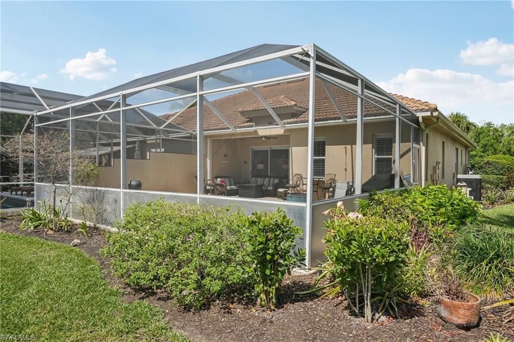 3653 Periwinkle Way Naples, FL 34114 - Photo 34 of 49 Back of property with glass enclosure, a sunroom, a ceiling fan, and stucco siding