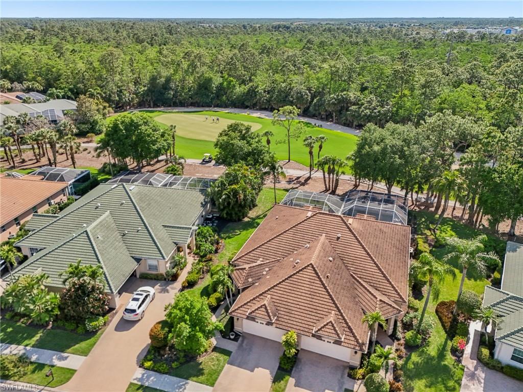 3653 Periwinkle Way Naples, FL 34114 - Photo 40 of 49 Aerial view of residential area featuring a golf course and a forest