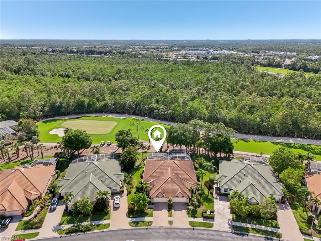 3653 Periwinkle Way Naples, FL 34114 - Photo 41 of 49 Aerial view of residential area featuring a golf course and a heavily wooded area