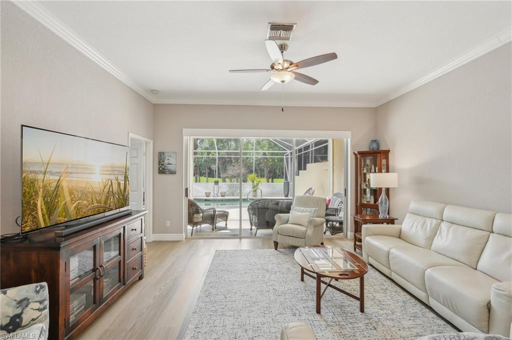 3653 Periwinkle Way Naples, FL 34114 - Photo 8 of 49 Living area with a sunroom, light wood-type flooring, a ceiling fan, and crown molding