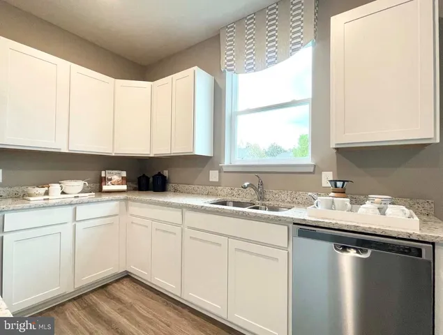 a kitchen with a table chairs refrigerator and cabinets