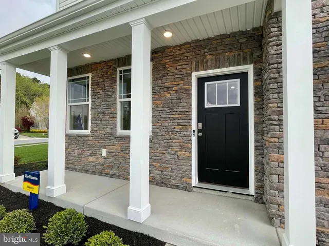 a hallway with wooden floor and a livingroom view